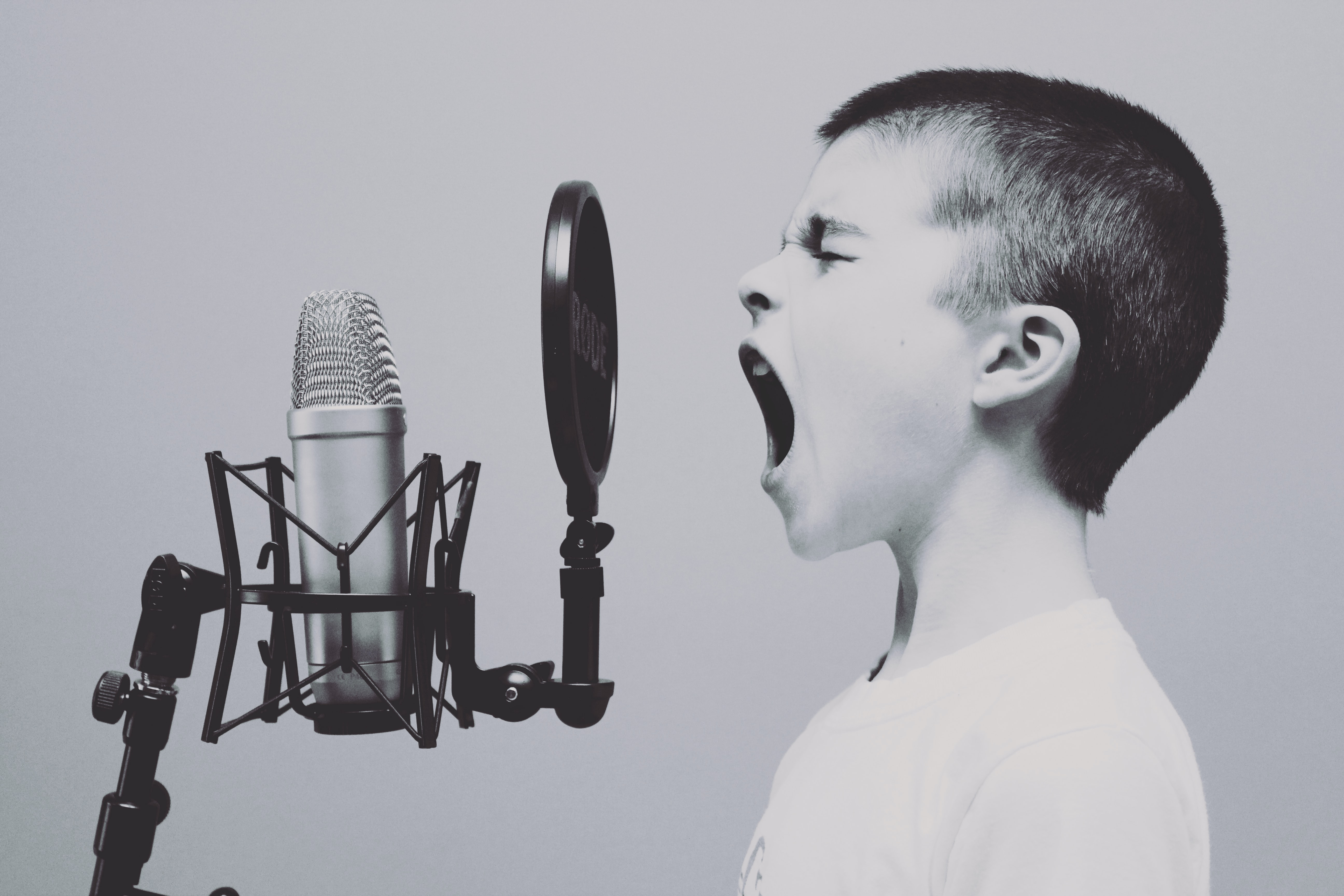 a child screaming into a studio microphone
